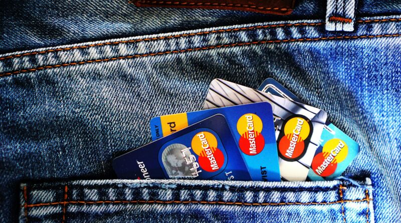 Close-up of a denim pocket with multiple credit cards, illustrating finance and fashion.