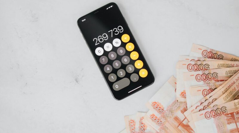 Smartphone displaying calculation with Russian rubles on a marble surface, representing finance and budgeting.
